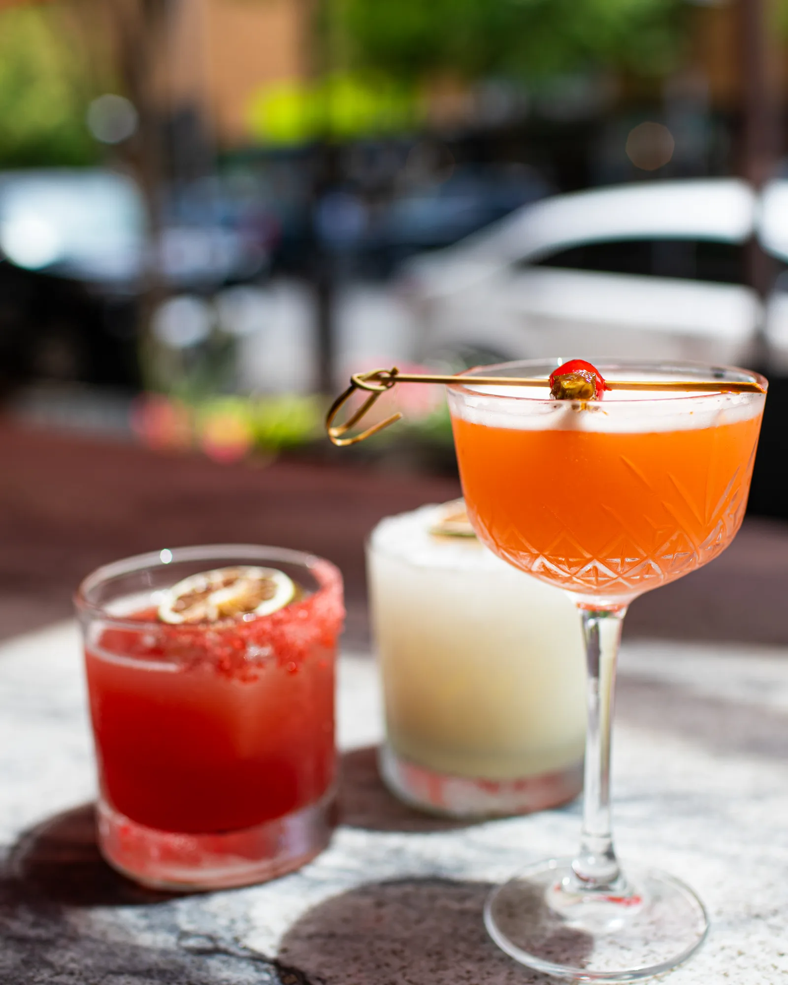 Three summer cocktails in the afternoon sun on the patio