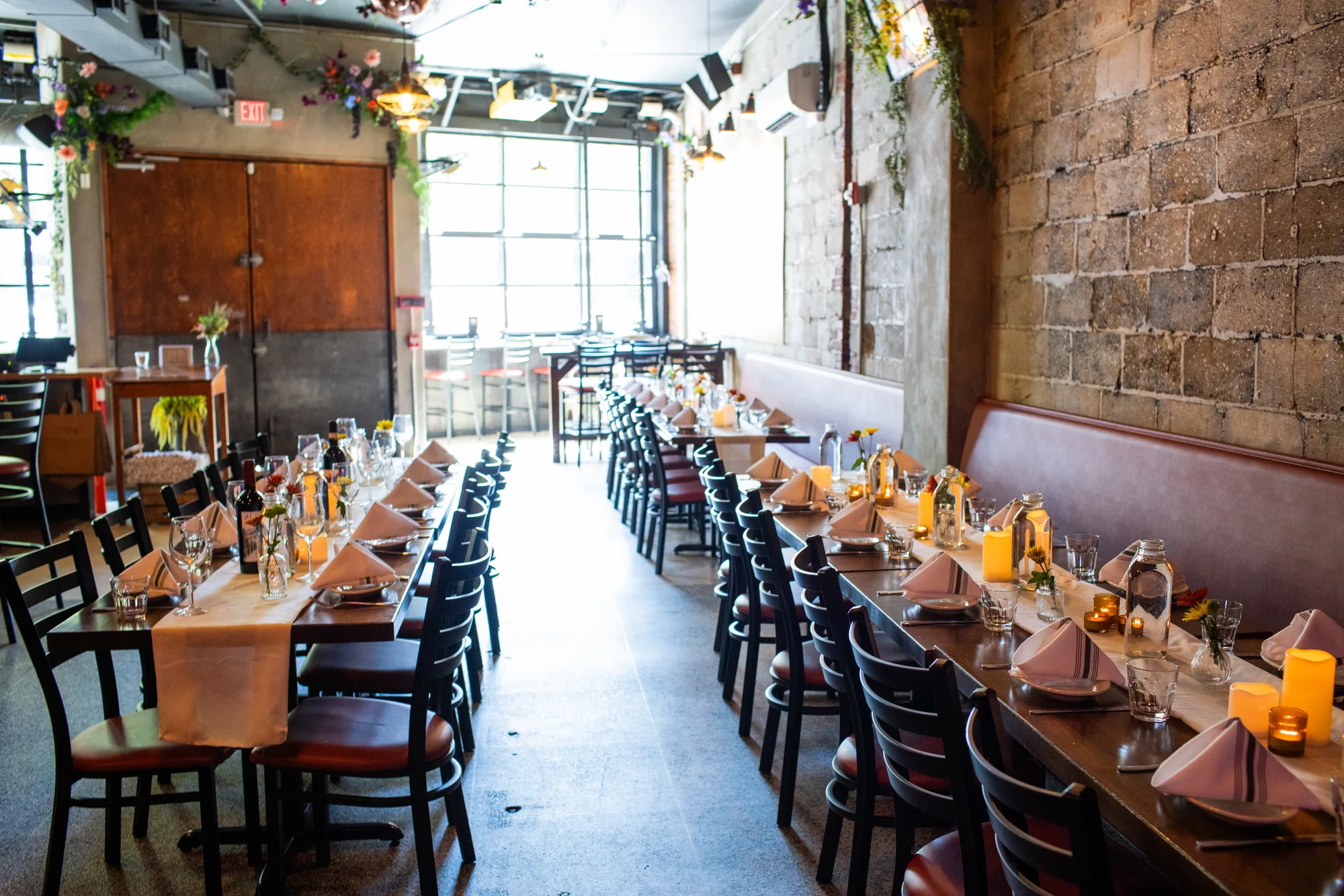 Capitoline's sunlit dining room at noon, doors open, tables set