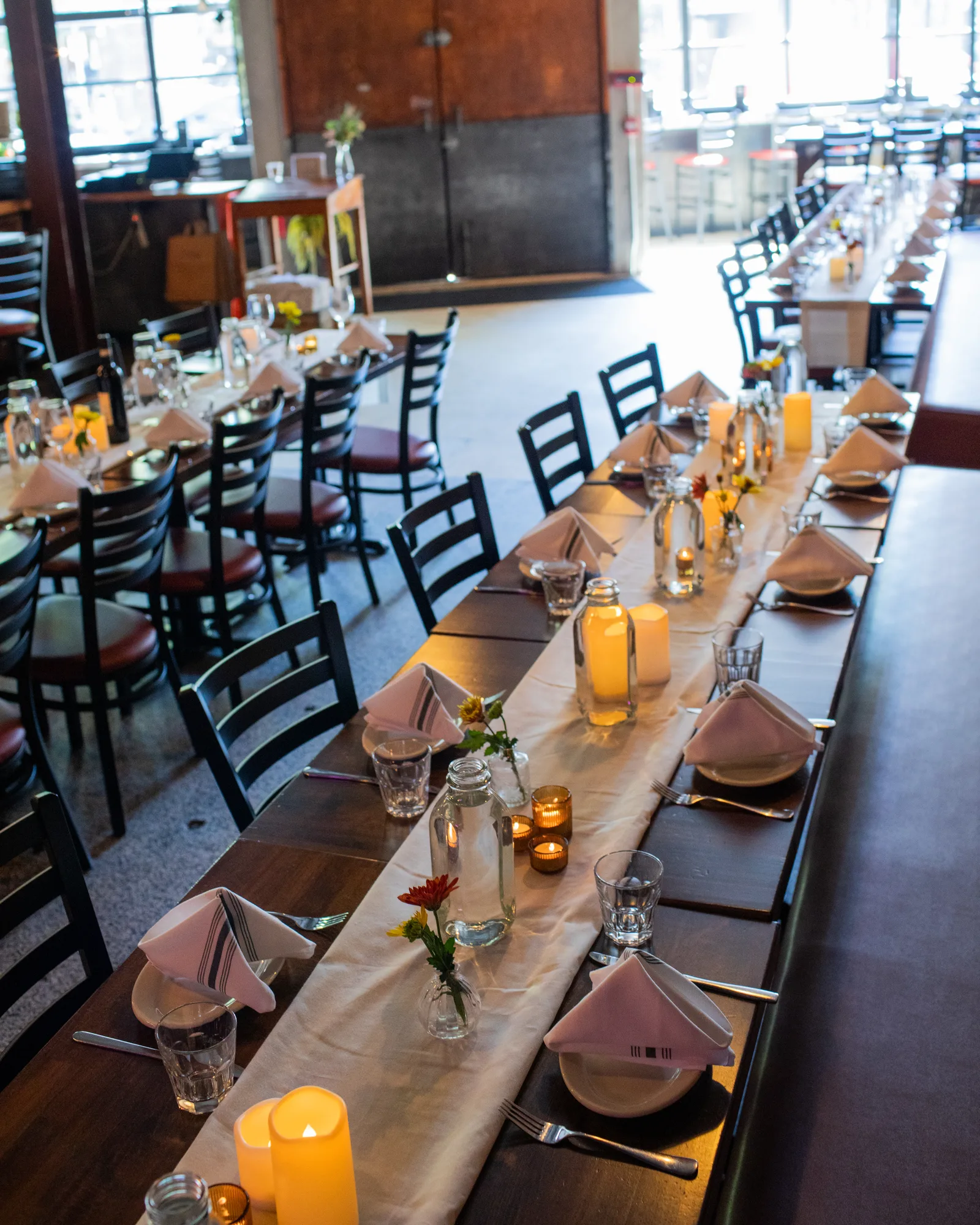 A sunlit long table set for a celebration
