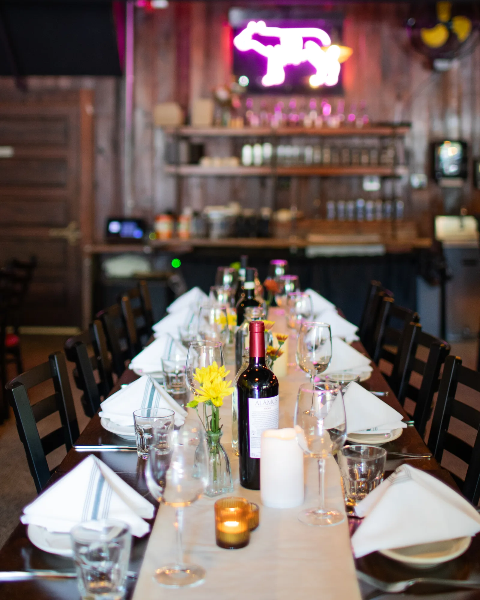 Capitoline's dining room at night, glowing under the neon wolf