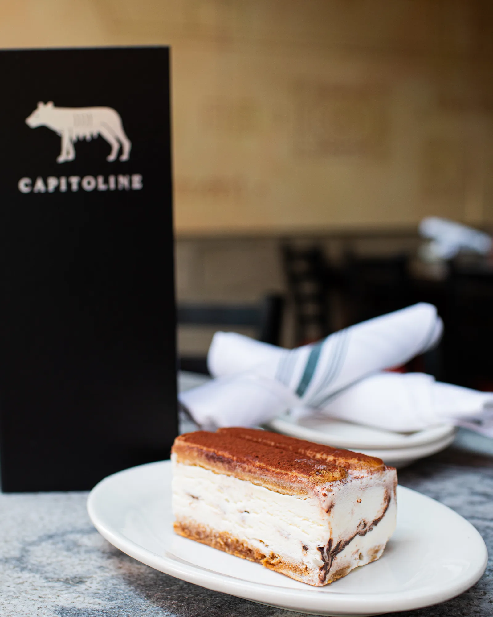 Tiramisu ice cream sandwich, cocoa-dusted, on a plate